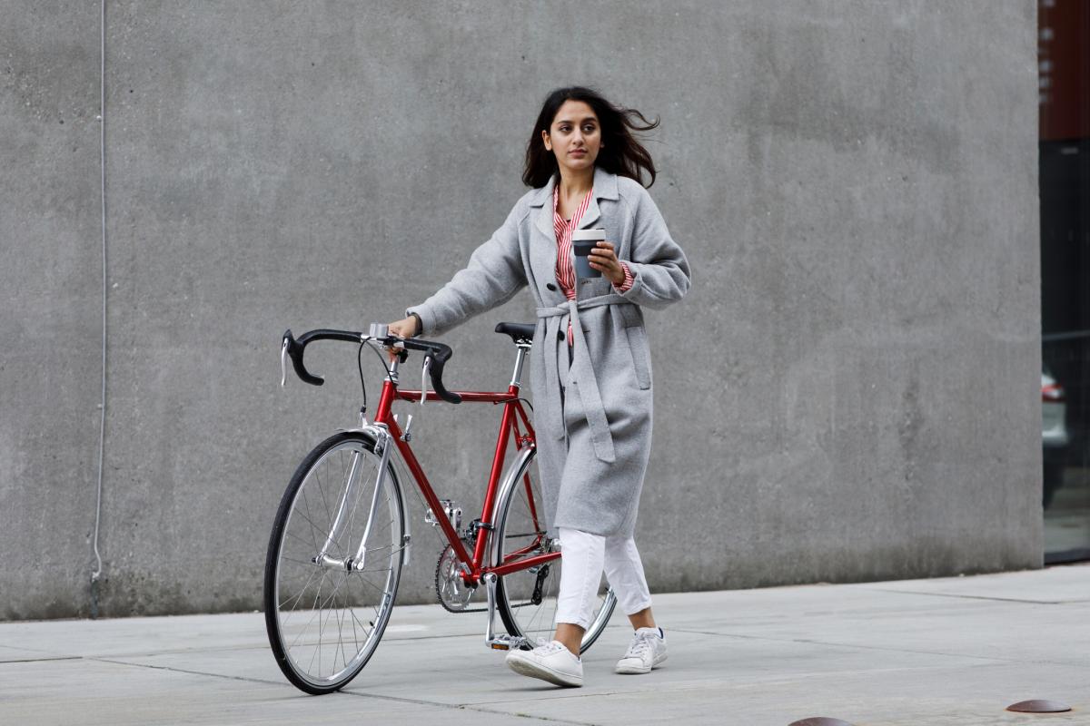 woman with bike and coffee